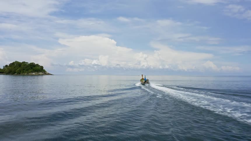 A boat motors across a body of water