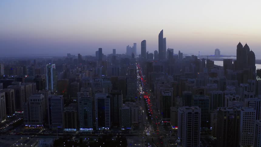 Car headlights light up downtown at night