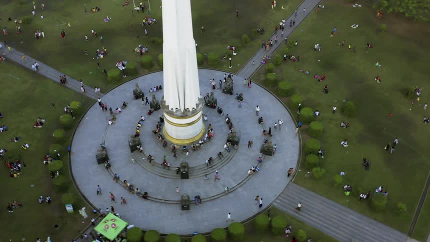 Pedestrian occupy park near monument