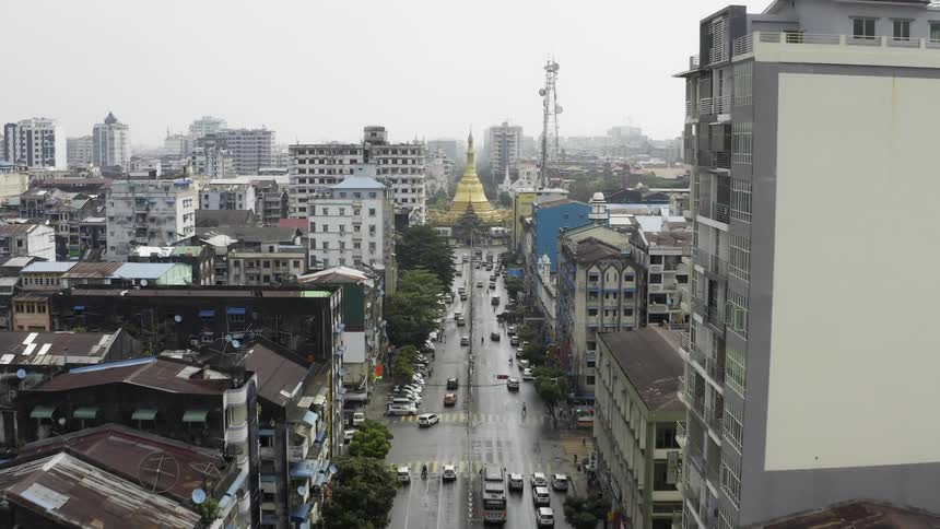 Traffic drives down streets in a large city