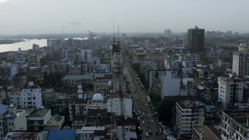 A large urban city next to a river is full of numerous tall residential towers