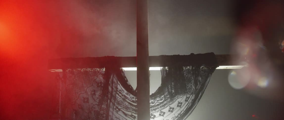 A close up footage of a cross in the dark