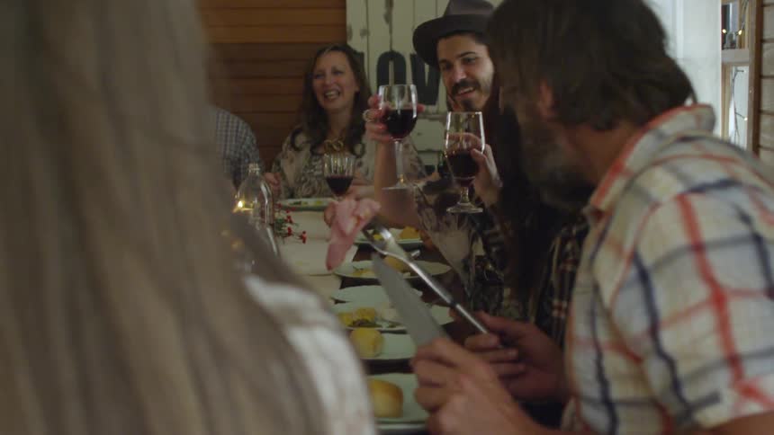 A family talking and eating at a dining table