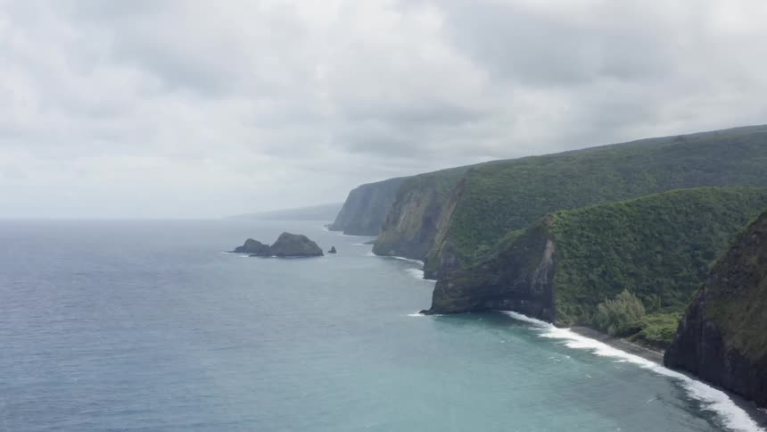 A beach with cliffs and the sky in the background