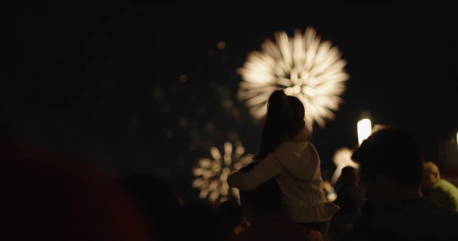 People watch the fireworks show at night