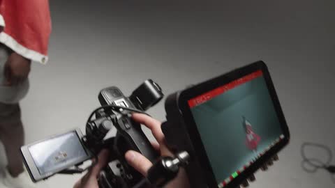 A man is filming in a studio