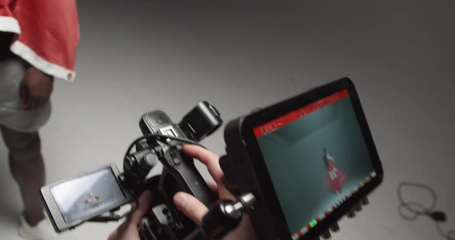 A man is filming in a studio