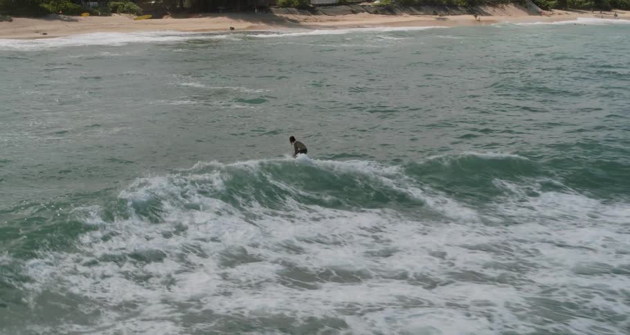 A man is riding the wave towards the shore