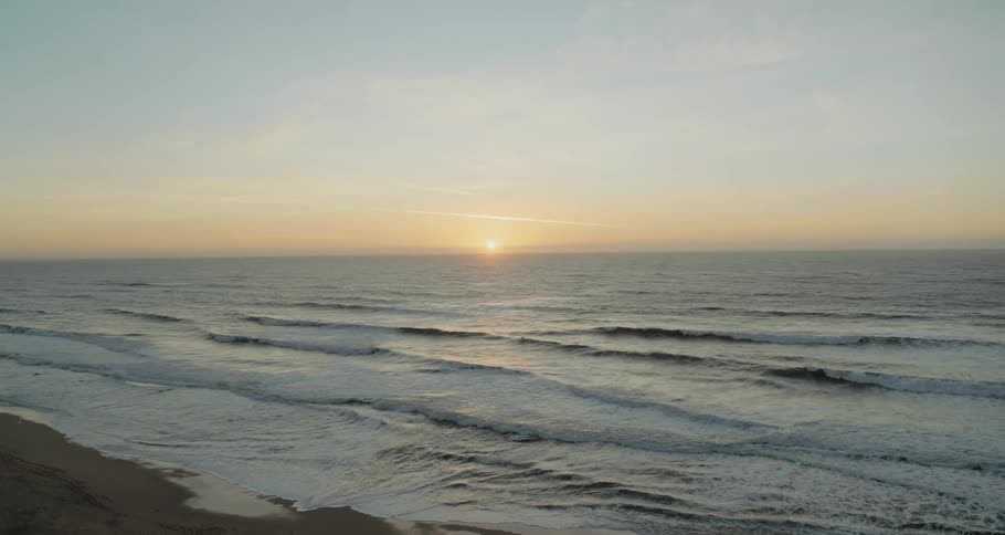 Waves crashing against the sandy coast