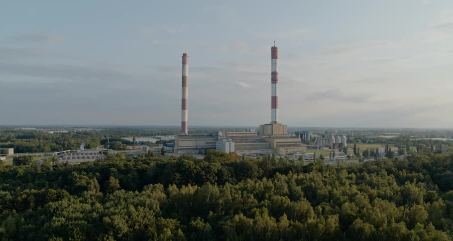 Large striped smoke stacks looming over a building