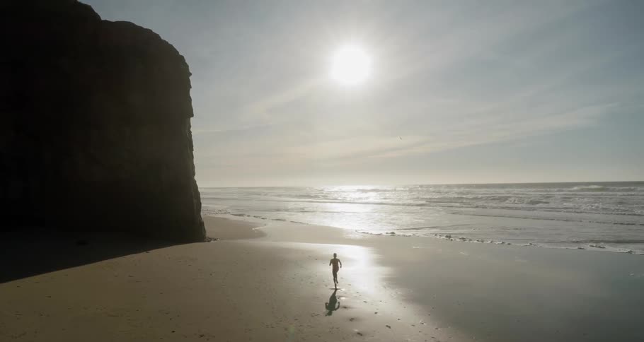 A person runs a long the beach