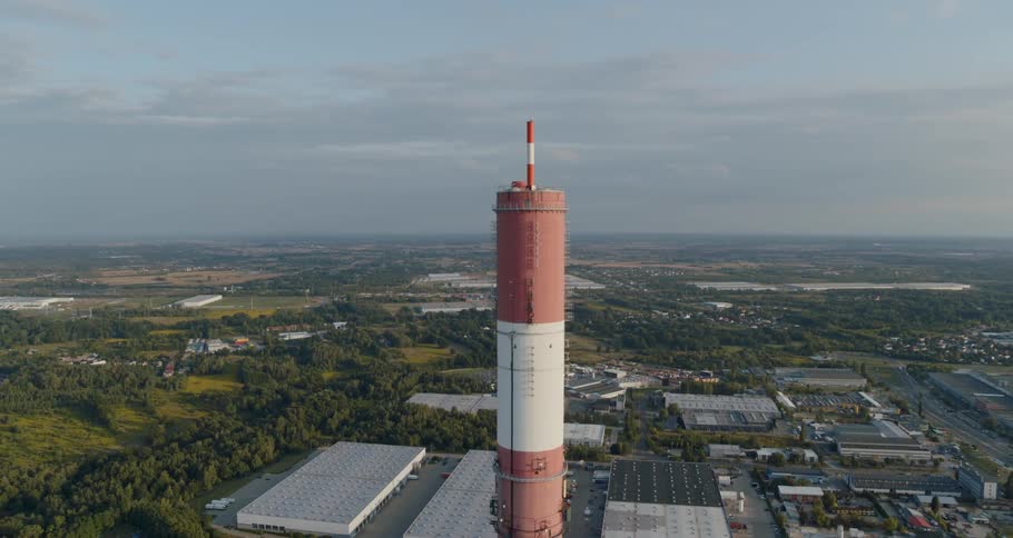 A chimney stack with the sky and clouds in the background