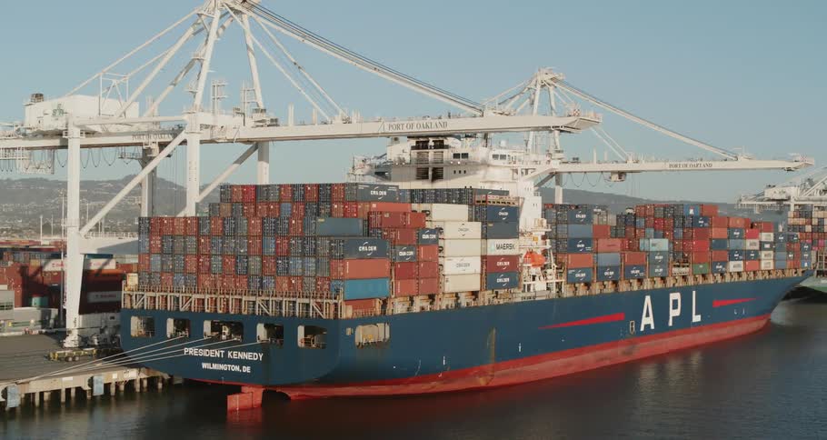 Shipping containers stacked high on a docked cargo ship