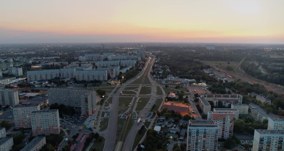 Traffic drives down a highway surrounded by apartment buildings