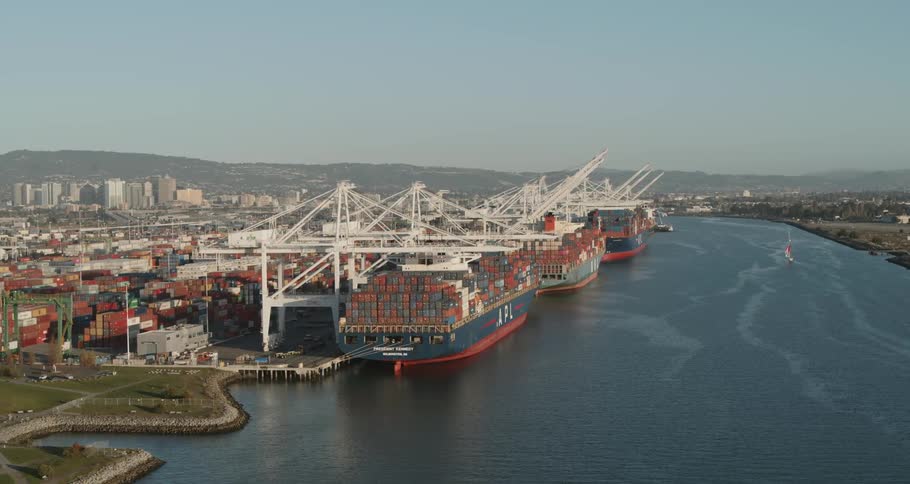 Cargo ships are ported at the receiving docks on a clear day