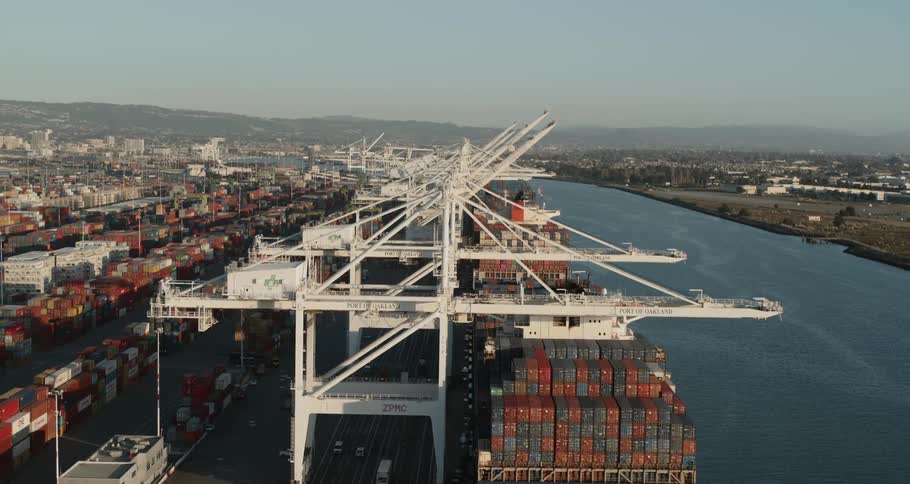 A shipping port with shipping containers and cranes