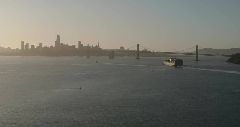 Skyline of a city downtown with a long bridge in front