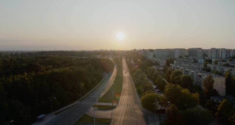 The road runs along the city with many buildings