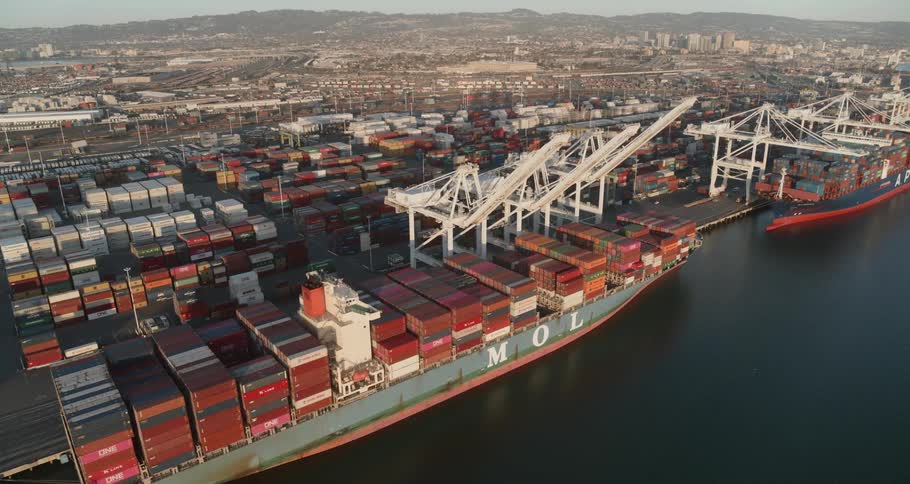 A shipping port with shipping containers and shipping tankers