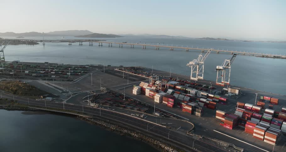 A shipping port full of containers and cranes