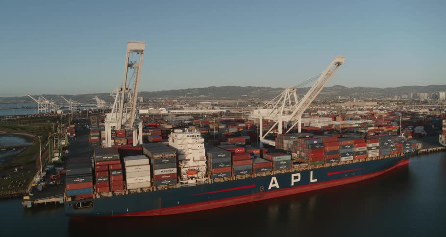A large freight ship is loading up in the port