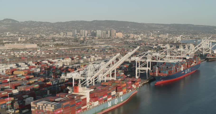 Large mol and apl emblazoned cargo ships docked at a commercial port