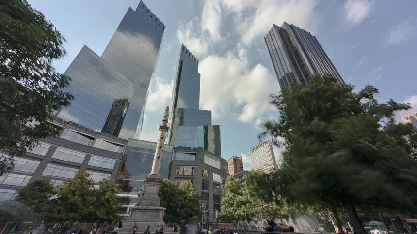 The sky reflecting off the windows of skyscrapers in a city during the day
