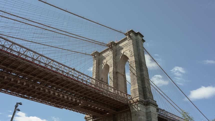 Clouds passing over a suspension bridge during the day