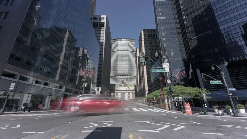 Cars go through an intersection in a big city