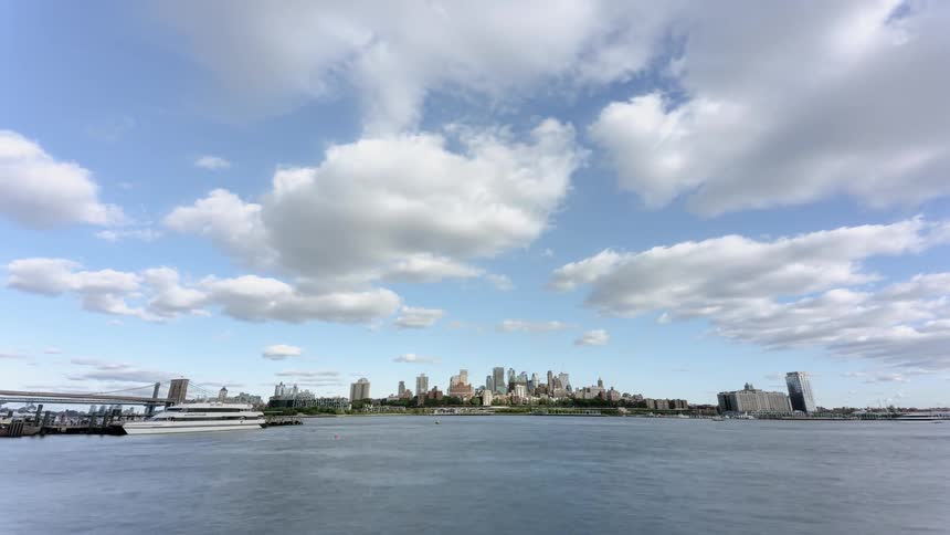 Time lapse of boats in a lake with the skyline in the background