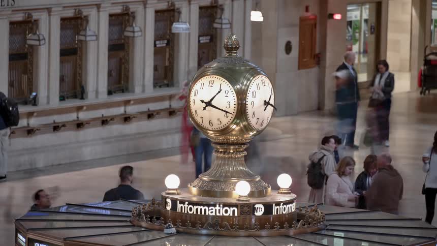 People pass through a train central station