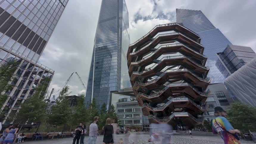 People walk around an architectural structure