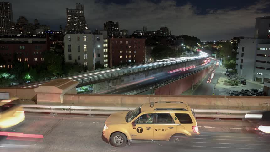 Cars drive over a bridge in the city