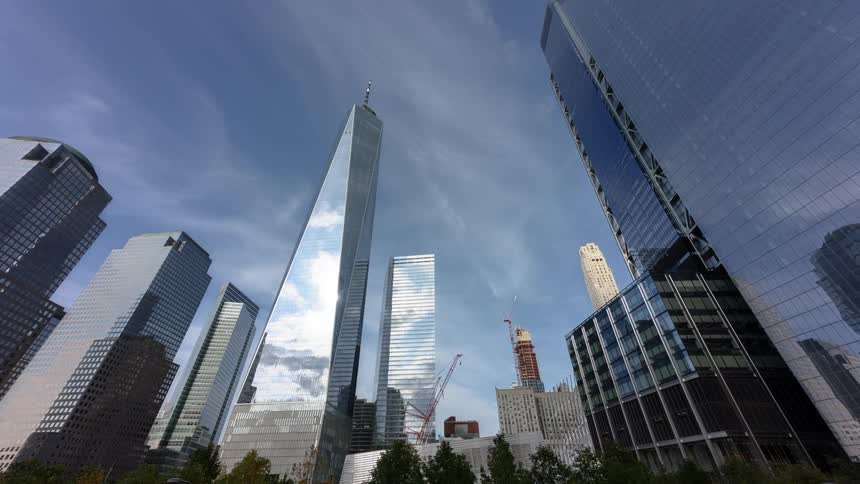 The sun reflects off of glass skyscrapers