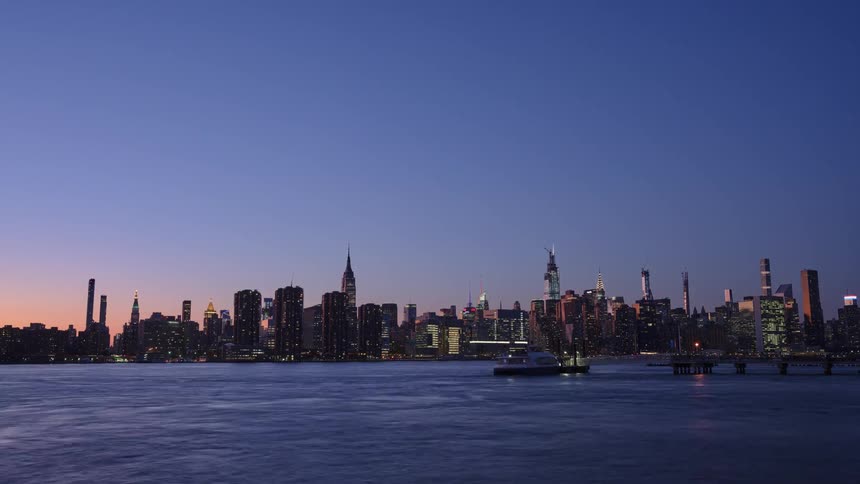 Time lapse of boats in the water with the skyline behind