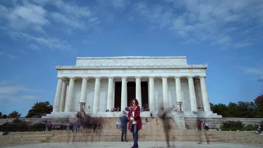 Tourists stop by and take pictures of a monument