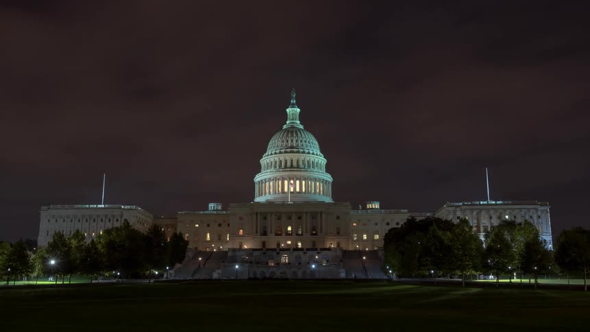 The us capitol building at night in washington dc