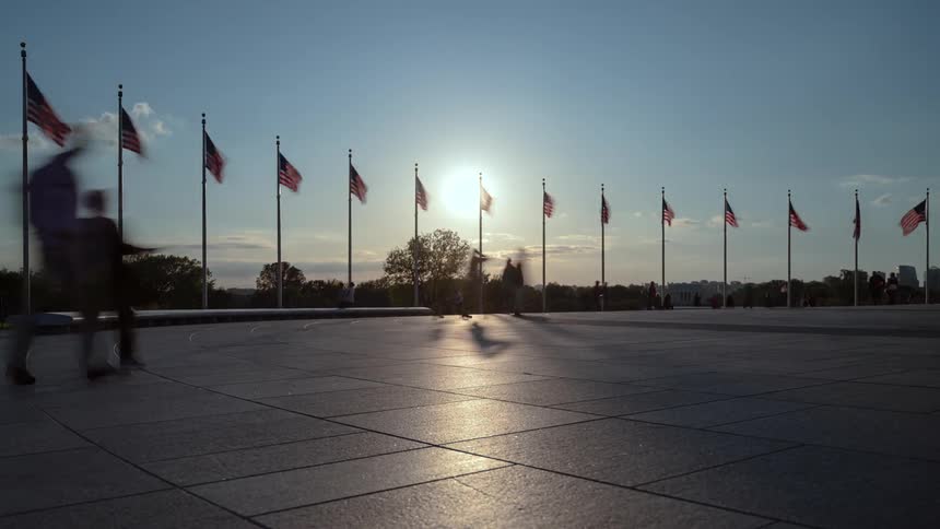 People walk around a us monument
