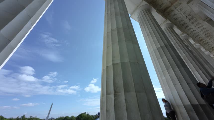 A classical architectural column connects a roof to the ground