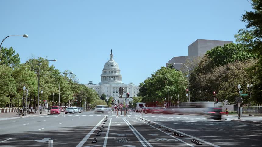 Traffic passes by on a multilane road in a capital city