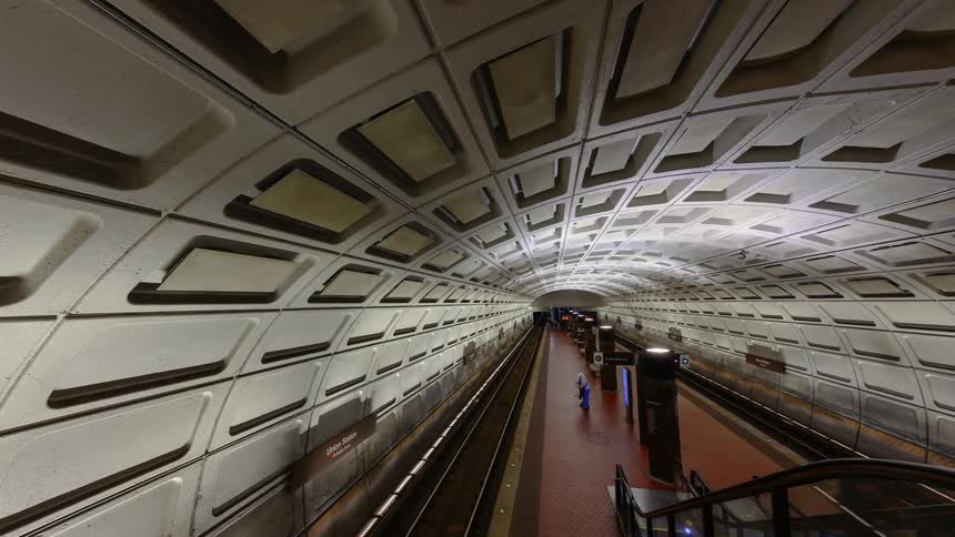 Pedestrians walk inside a subway tunnel