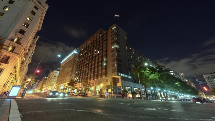 A busy intersection in a city at night