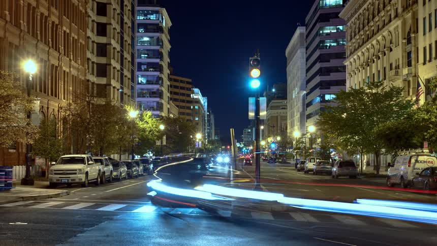A busy intersection in a metropolis at night