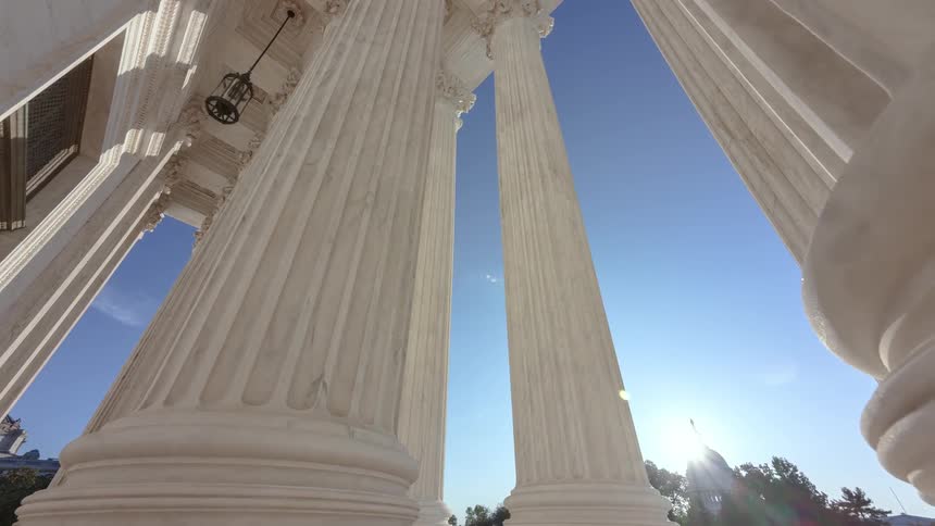 Tall columns sit under a blue sky