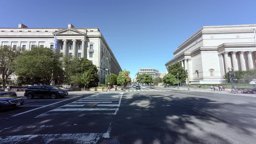 People and traffic move through an intersection in washington dc