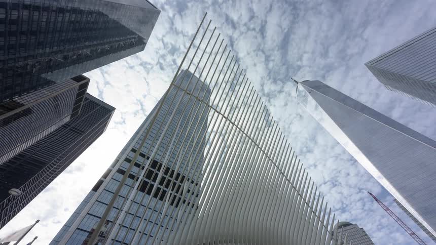 Tall skyscrapers sit under the cloudy sky