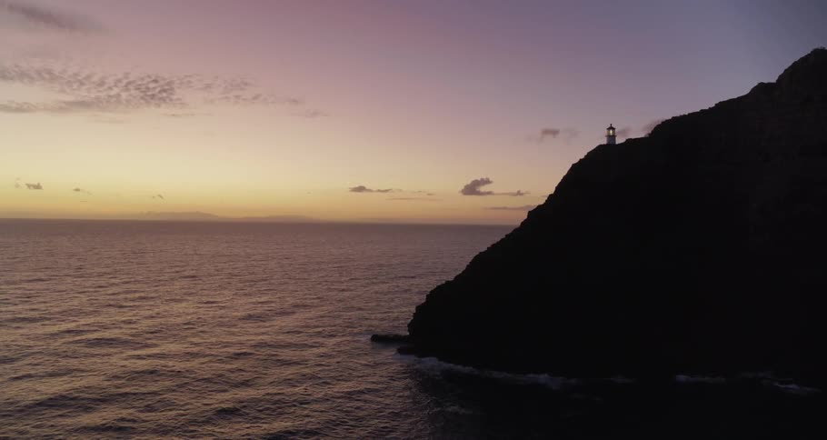 A lighthouse on a promontory bordering the ocean