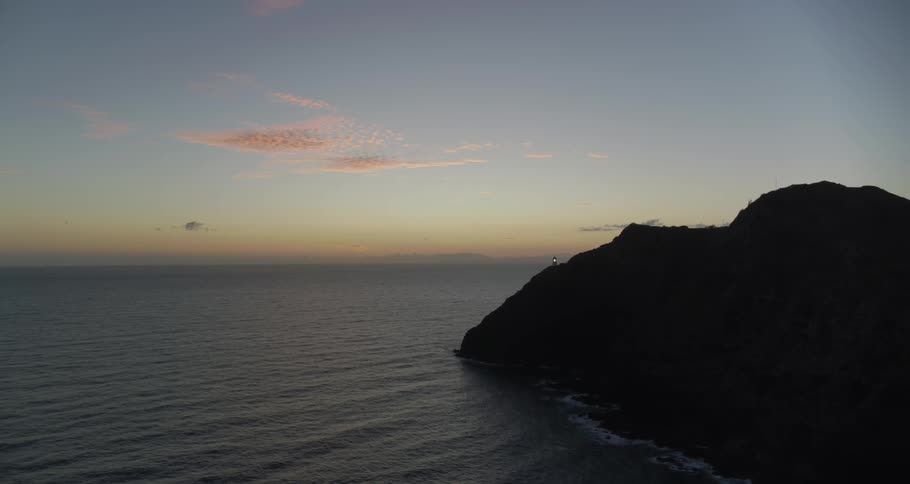 An aerial view of an ocean shoreline at sunset