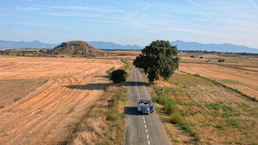 Two women driving a car down a country road