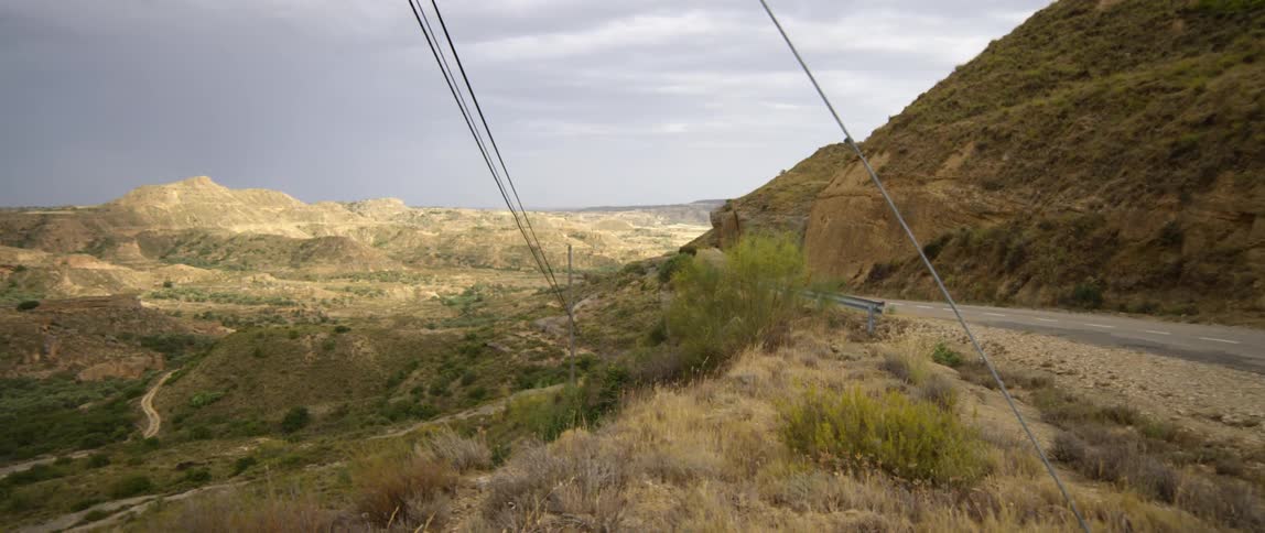 A narrow road winds along a mountain